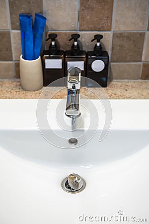 Chrome faucet washbasin. Interior of bathroom with sink basin faucet. Stock Photo