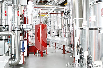 Chrome pipes in heating and AC rooms in buildings of factories a Stock Photo