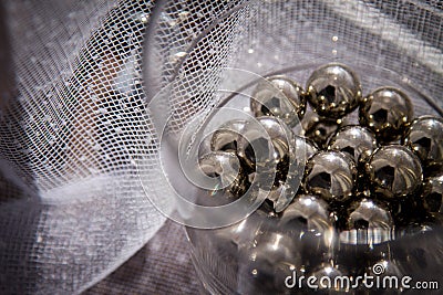 Chrome spheres in clear glass next to the window. Stock Photo