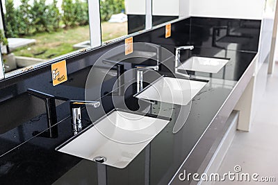 Chrome tap bathroom and dust on the surface do not clean and sensor for automatic open and close water supply. Ceramic sink and mo Stock Photo