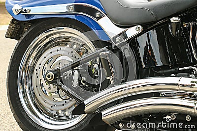 Chrome wheel, exhaust and trims of a blue motorcycle Editorial Stock Photo