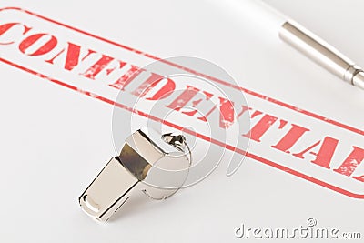 Chrome whistle on documents with confidential top secret information on wooden office desk - whistleblower concept Stock Photo