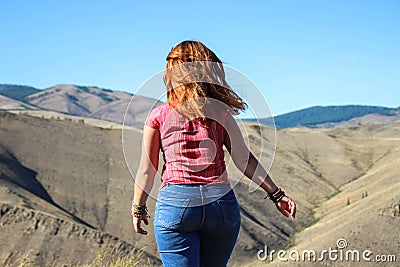 Chubby girl tourist with red hair in jeans Stock Photo