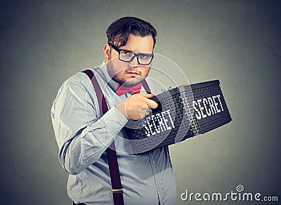 Suspicious business man keeping secrets Stock Photo