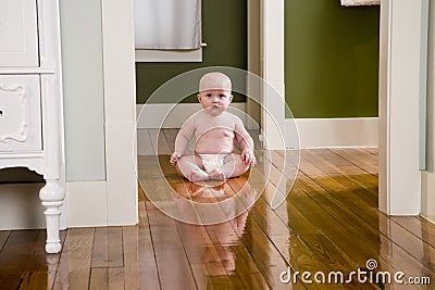 Chubby seven month old baby at home on floor Stock Photo