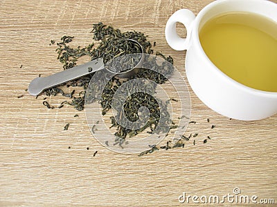 Chun mee in tea spoon and a cup of green tea Stock Photo