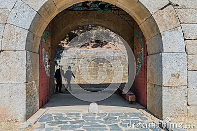 Chungju, South Korea; March 22,2020: Two men hiking together at gate of Sangdang Fortress despite social distancing rules in place Editorial Stock Photo