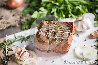 Chunk of salted smoked lard in gauze with a rope.Traditional Russian and Ukrainian meal.Healthy food with spices, herbs Stock Photo