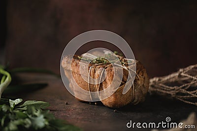 Chunk of salted smoked lard in gauze with a rope.Traditional Russian and Ukrainian meal.Healthy food with spices, herbs Stock Photo