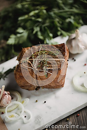 Chunk of salted smoked lard in gauze with a rope.Traditional Russian and Ukrainian meal.Healthy food with spices, herbs Stock Photo