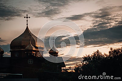 Village church on a dark warm sunset background Stock Photo