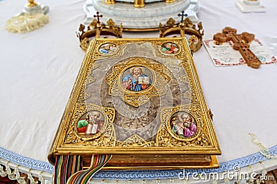 Church attribute a golden Bible with a lock on the altar, gospel, holy, gold crowns for brides with crosses Stock Photo