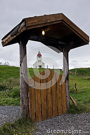 Church in background of Modrudalur farm entrance gate, Iceland Stock Photo