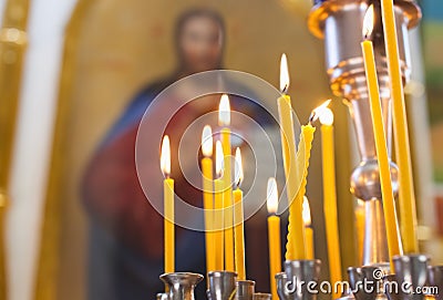 Church candles burn in the church Stock Photo