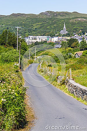 Church, city, mountains and vegetation in Clifden Editorial Stock Photo