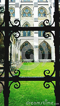 Church courtyard through wrought iron window Stock Photo