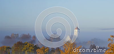 Church at dawn in the fog. Autumn landscape. Early morning in the village Stock Photo