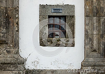 Church front facade with small window for donation or alms Stock Photo