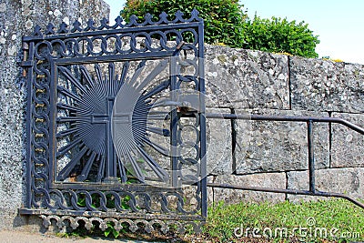 Church Gate of Wrought Iron with a Cross Stock Photo