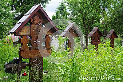 High wooden crosses in the graveyard of The Church of the Holy Archangels in Rogoz village, Maramures County, Romania, Europe. Editorial Stock Photo