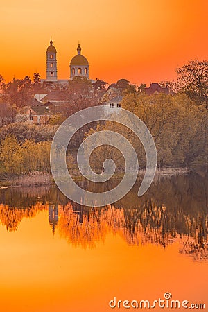 Church and houses at sunset, dawn Stock Photo