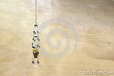 Church interior background. Hanging lighting against a rustic wall. Stock Photo