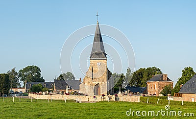 The church in the middle of the traditional French village of Saint Sylvain in Europe, France, Normandy, Seine Maritime, in summer Stock Photo