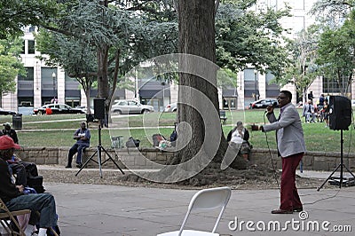 A church minister preaching to homeless men and w Editorial Stock Photo