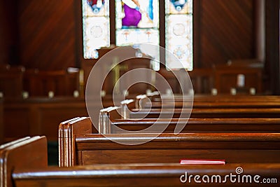 Church Pews with Stained Glass Beyond Pulpit Stock Photo