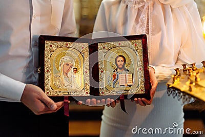 CHURCH OF THE RESURRECTION, VICHUGA, RUSSIA - NOVEMBER 03, 2019: Icon in the hands of the bride and groom at the wedding Editorial Stock Photo