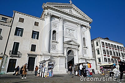 Facade of a Catholic church with tourists and hawkers in front Editorial Stock Photo