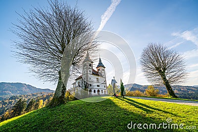 Church of St. Volbenka in autumn colors against a blue sky, Slovenia, Europe Stock Photo