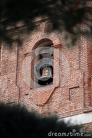 Church tower with bell in the village Stock Photo