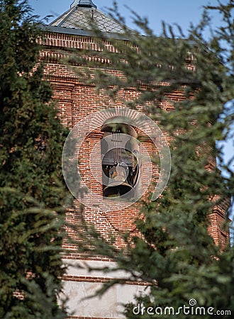 Church tower with bell in the village Stock Photo