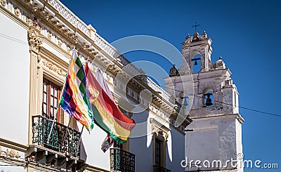 Church tower and Wiphala and Bolivia Flags - Sucre, Bolivia Stock Photo