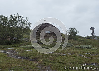 Church at traditonal saami style at Staloluokta sami village at Virihaure lake. Summer moody and foggy day at Stock Photo