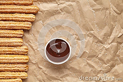 Churros traditional Spain breakfast or lunch street fast food baked sweet dough snack dessert with chocolate dipping Stock Photo