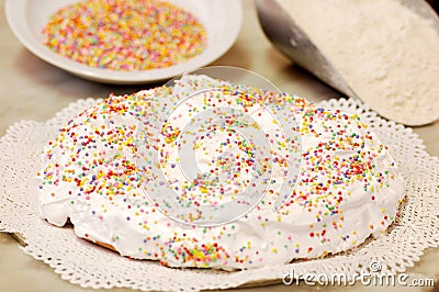 The ciaramicola is a typical Umbrian Easter cake; it is a donut-shaped cake, red in color with white icing and colored topping spr Stock Photo