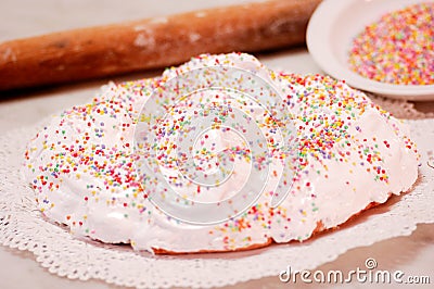 The ciaramicola is a typical Umbrian Easter cake; it is a donut-shaped cake, red in color with white icing and colored topping spr Stock Photo