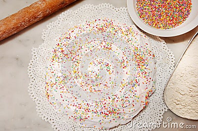 The ciaramicola is a typical Umbrian Easter cake; it is a donut-shaped cake, red in color with white icing and colored topping spr Stock Photo