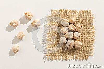 Chickpeas legume. Close up of grains spread over white table. Stock Photo