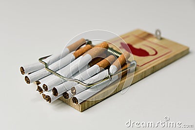 Cigarettes in a mousetrap Stock Photo