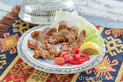 Cigkofte turkish meatball from bulgur with tomato, lemon, and le Stock Photo