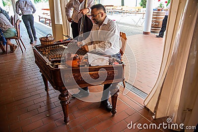 A cimbalom is a marimba like instrument played here by a musician during lunch at the puszta tour horse show expedition Editorial Stock Photo