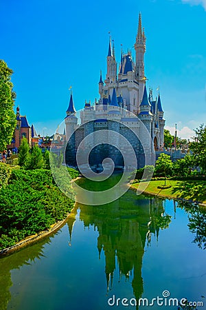 Cinderella`s castles reflecting in a lake in Magic Kingdom, Orlando, Florida Editorial Stock Photo