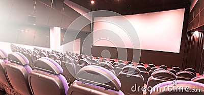 Cinema auditorium with line of red chairs, sitting visitors and silver screen. Ready for adding your own picture Stock Photo