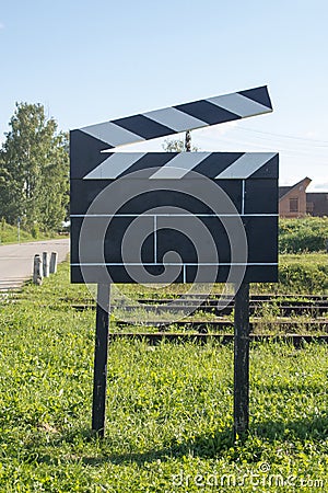 Cinema Concept Big Size Movie Clapper at Ourside on Green Grasses at Outside Stock Photo