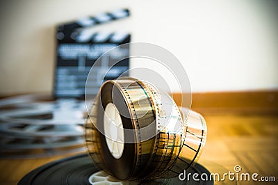 Cinema film reel and out of focus movie clapper board Stock Photo