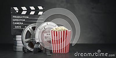 Cinema movie concept background. Film reel and tape, popcorn an Stock Photo