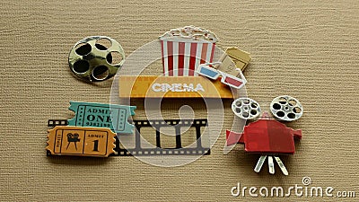 Cinema sign with popcorn tub 3d glasses movie tickets projector on tan background Stock Photo